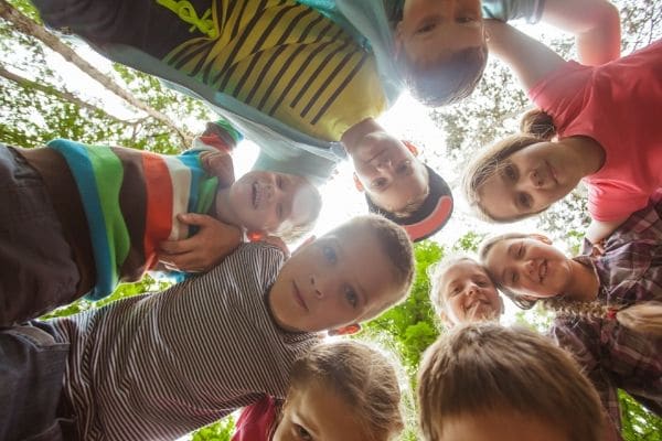 A group of children at a summer camp taking a photot together.