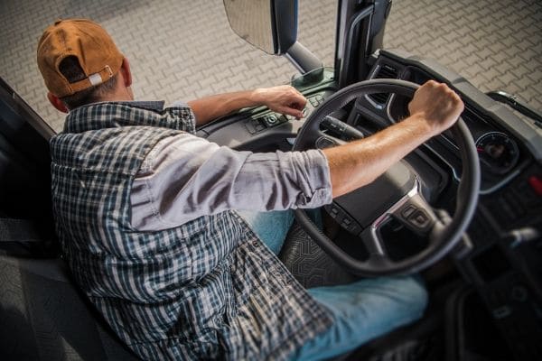 A man operating a large truck