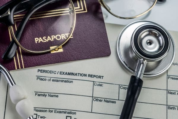 Passports, documents, and a stethoscope resting together